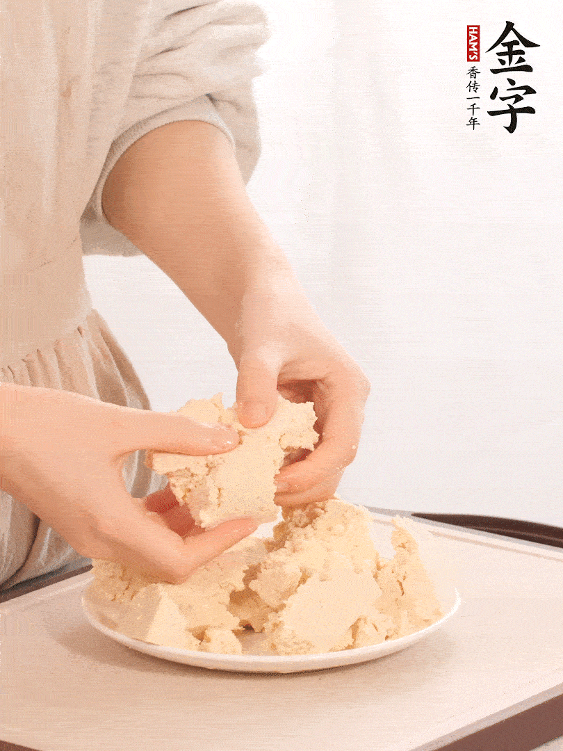 老豆腐用手掰成塊。